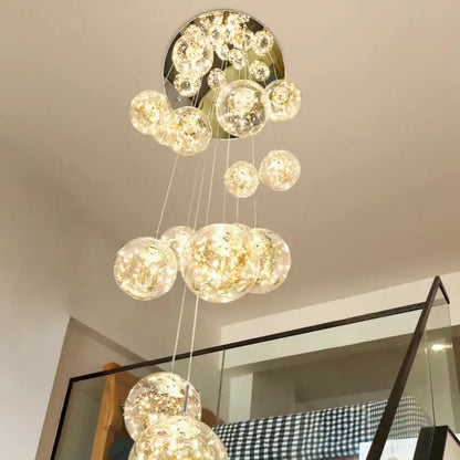 A modern decorbites luminous glass ball pendant chandelier with spherical glass orbs emitting warm golden light