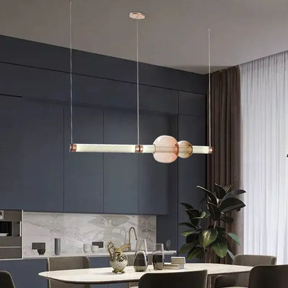 Modern luna glass tube chandelier with two translucent pink orbs and copper accents for kitchen dining or staircase lighting