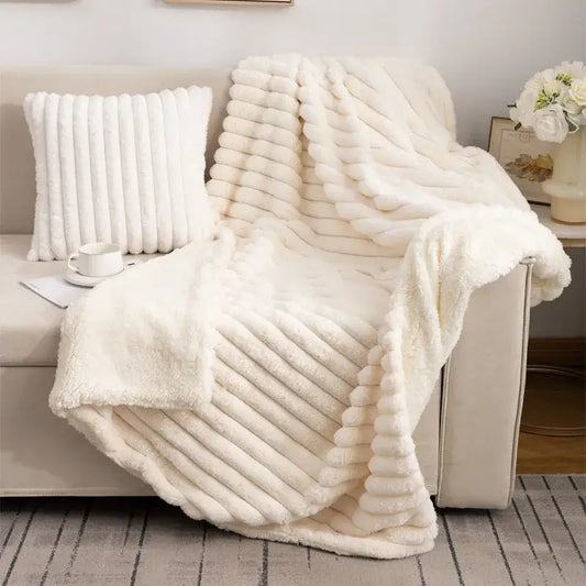 Cream-colored decorbites luxe double-layer blanket with faux-rabbit fur and ribbed textured plush surface for cozy warmth