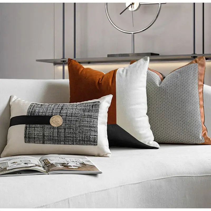 Cream-colored rectangular cushion cover with black band textured gray luxe flannelette leather patch and metallic button by decorbites luxe flannelette