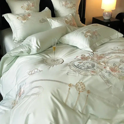 Luxurious light green satin bedding set with intricate pink peach silver floral embroidery and gold tassels by DecorBites Luxe Floral