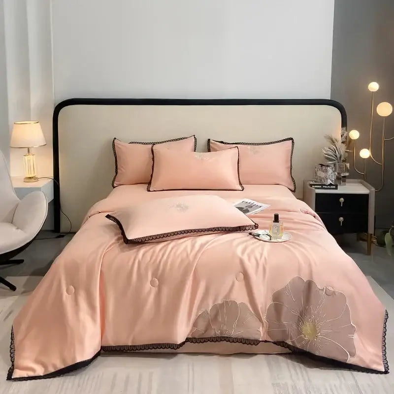 Pink satin quilt set with embroidered floral design and black lace trim from decorbites luxe flower embroidered collection