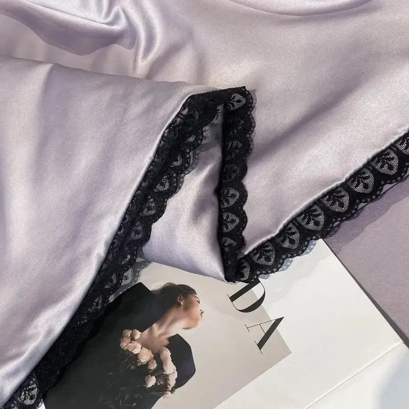 Silver-gray satin quilt set with black lace trim and embroidered floral design from decorbites luxe flower embroidered collection