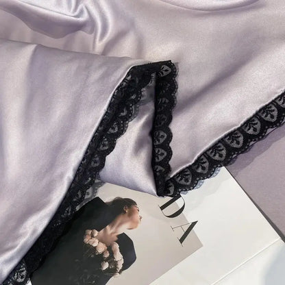 Silver-gray satin quilt set with black lace trim and embroidered floral design from decorbites luxe flower embroidered collection