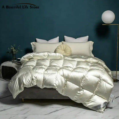 Cream-colored satin quilt with subtle embroidery and plush texture in decorbites luxe goose duck down quilt queen king size