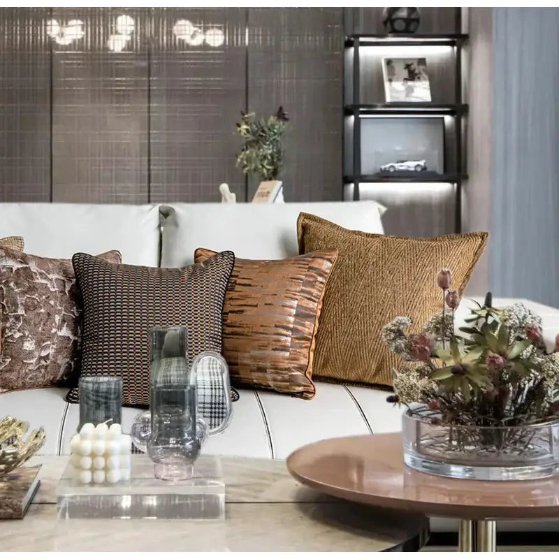 A modern white leather sofa with decorbites luxe jacquard cushion covers in brown gold coffee color 45x45cm