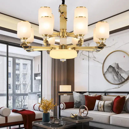 DecorBites Luxe Jade chandelier brass finished with frosted glass shades and ornate detailing for living room use