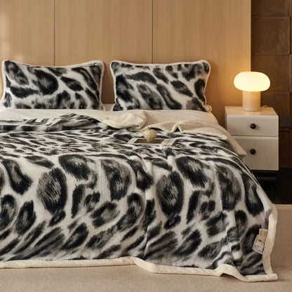 A black and white leopard-print fleece blanket with soft plush texture from decorbites luxe leopard rabbit fur collection