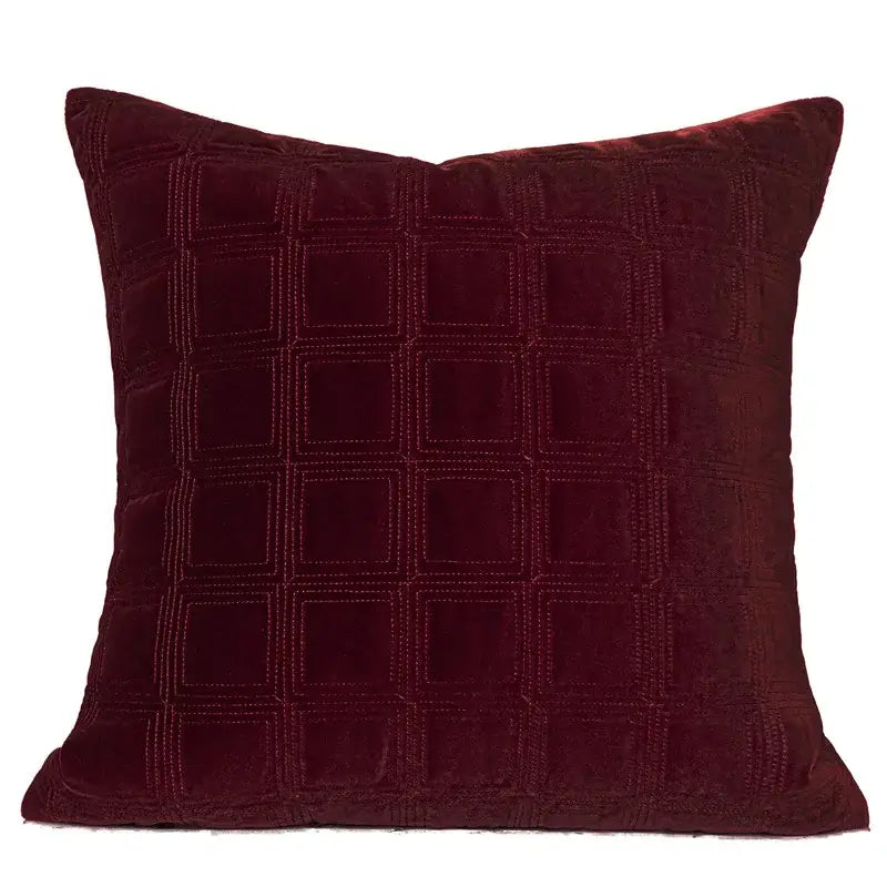 A deep burgundy velvet throw pillow with a quilted grid pattern from DecorBites luxe linen blend cushion covers