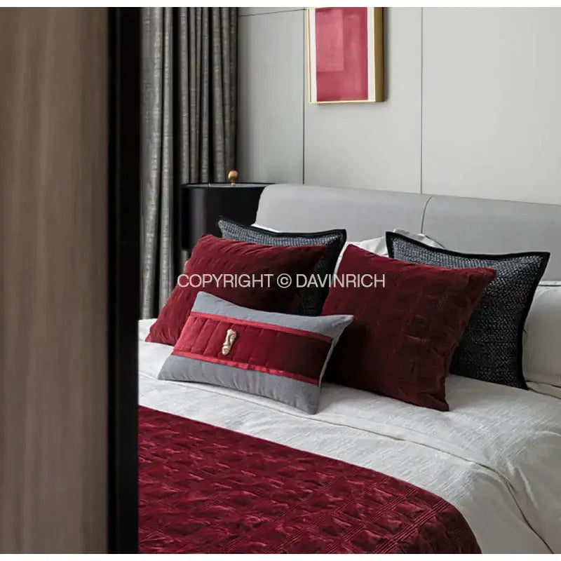 A deep red velvet throw with quilted diamond pattern complements decorbites luxe linen blend cushion covers set