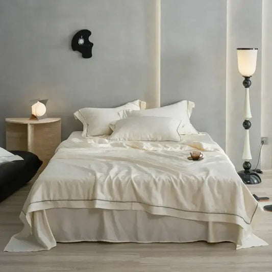 Cream-colored decorbites luxe lyocell summer blanket with mulberry silk fill comforter featuring black piping edges