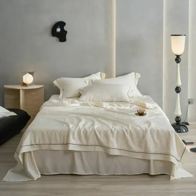 Cream-colored decorbites luxe lyocell summer blanket with mulberry silk fill comforter featuring black piping edges
