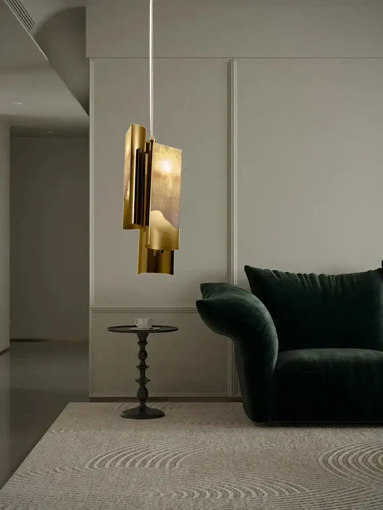 A modern gold-toned decorbites luxe marble pendant light with layered geometric design for kitchen island or dining table