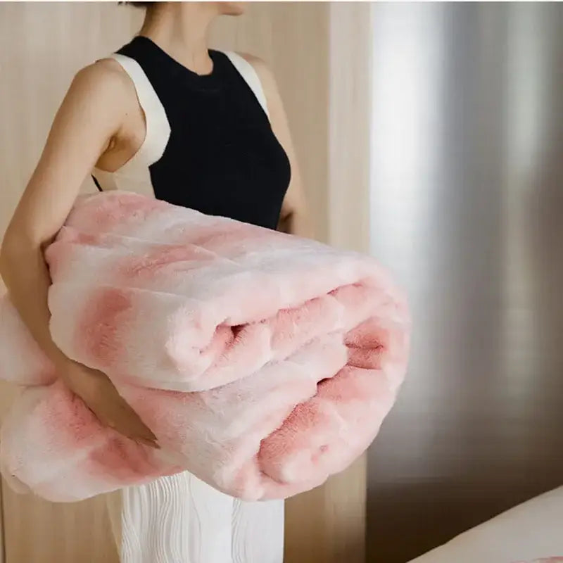 A plush gradient pink decorbites luxe milk velvet blanket with thick soft faux fur for home and office use