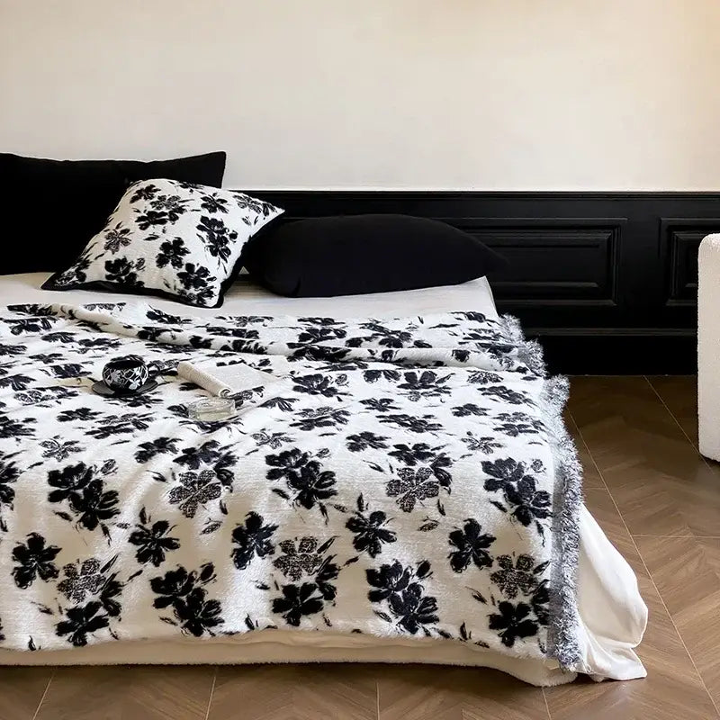 White plush mink fur throw with black floral jacquard pattern and fringed edges by decorbites luxe mink