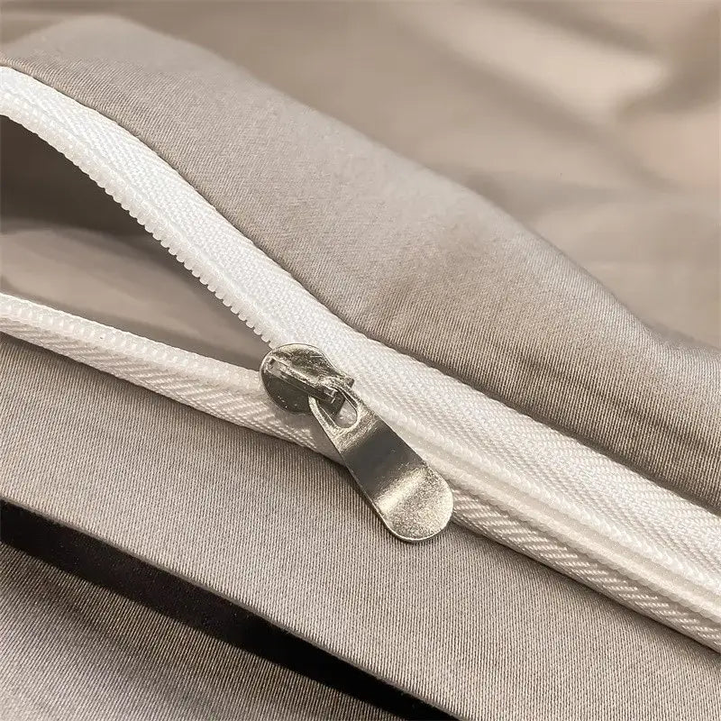 Silver zipper with metallic pull tab on light gray fabric of DecorBites™ luxurious 1000TC Egyptian cotton duvet cover