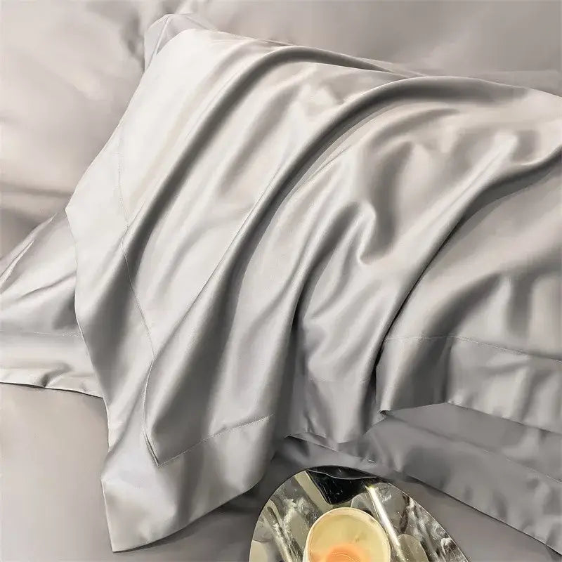 A luxurious silver-gray satin pillowcase from DecorBites™ 1000TC Egyptian cotton bedding set with elegant folds