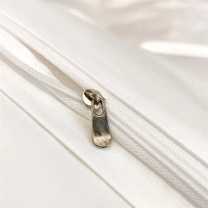 Silver-toned zipper pull on white fabric zippered seam of decorbites luxurious 1000tc egyptian cotton duvet cover