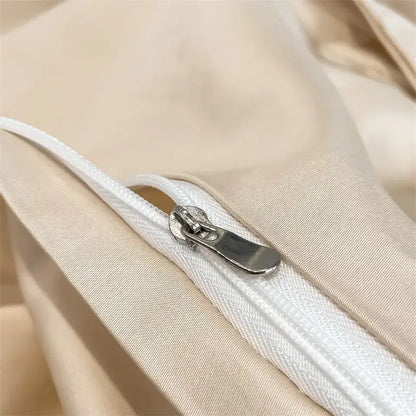 A sleek silver zipper on a beige DecorBites™ 1000TC Egyptian cotton duvet cover for luxurious bedding
