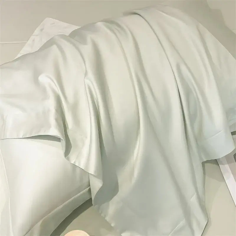 A soft off-white satin pillowcase with a smooth texture from the DecorBites™ luxurious 1000TC Egyptian cotton bedding set including duvet cover and fitted sheet