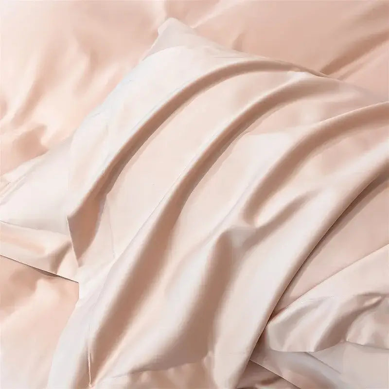 A soft blush pink satin pillowcase with smooth lustrous finish from DecorBites™ 1000TC Egyptian cotton bedding set including duvet cover and fitted sheet