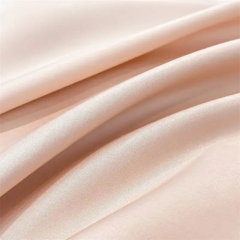 Soft peach-colored satin finish on decorbites luxurious 1000tc egyptian cotton duvet cover and fitted sheet set