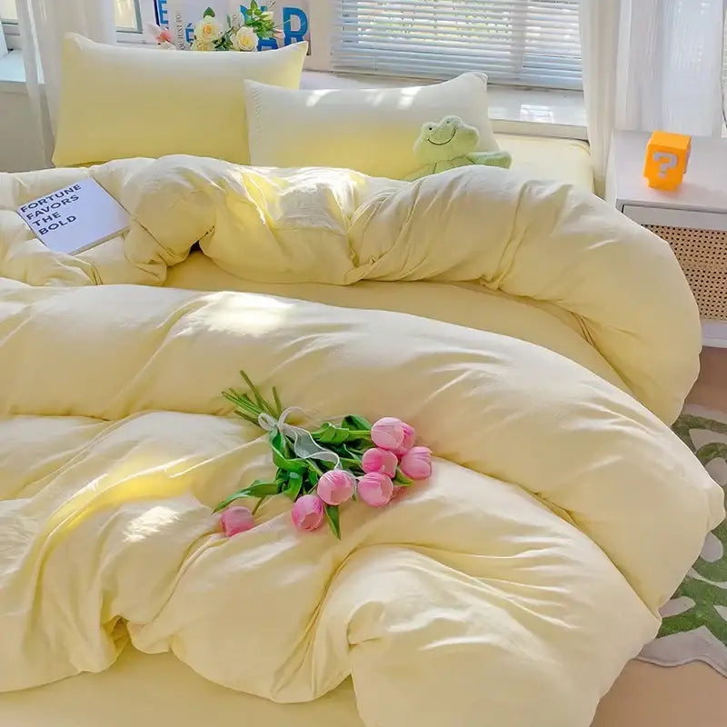 Soft pale yellow quilted cotton bedding set with plush texture and pink tulip bouquet for luxurious comfort