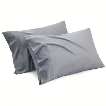 Two matching gray pillowcases from decorbites™ luxurious cooling sheet set with smooth, slightly shiny fabric finish