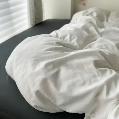 A soft white cotton duvet cover with textured fabric and gentle folds from decorbites luxurious bedding set