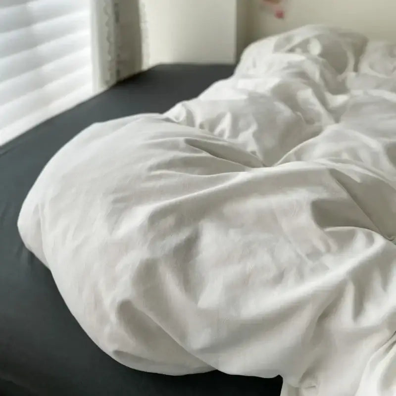 A soft white cotton duvet cover with textured fabric and gentle folds from decorbites luxurious bedding set
