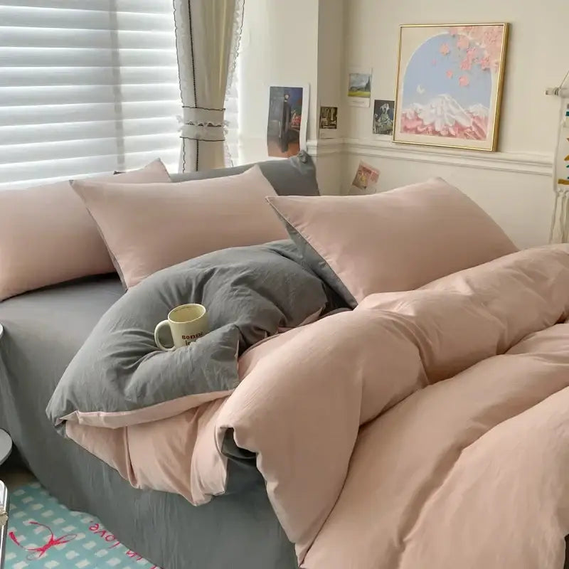 A cozy DecorBites™ cotton bedding set with soft pink and gray duvet cover and matching pillows for single and couple beds