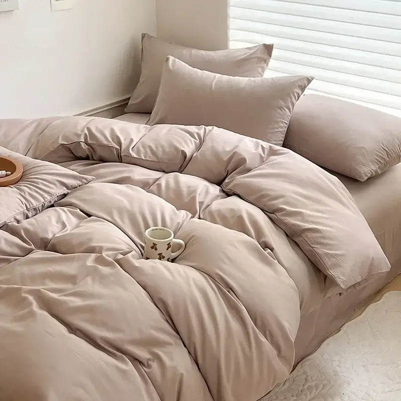 Beige quilted cotton bedding set with matching pillows featuring soft fabric finish and subtle stitching details