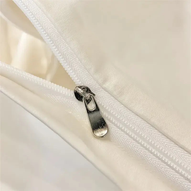 Silver zipper pull on white fabric seam of DecorBites™ luxurious Egyptian cotton duvet cover 1000TC piece duvet cover