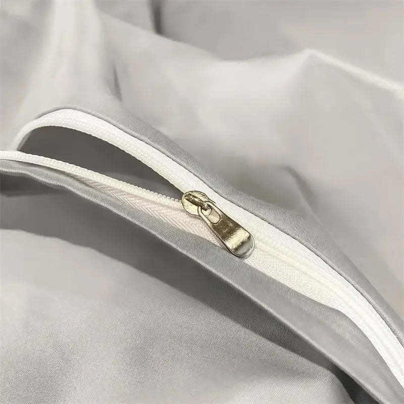 Silver-toned zipper with metallic pull tab on soft white egyptian cotton duvet cover from decorbites luxurious bedding set