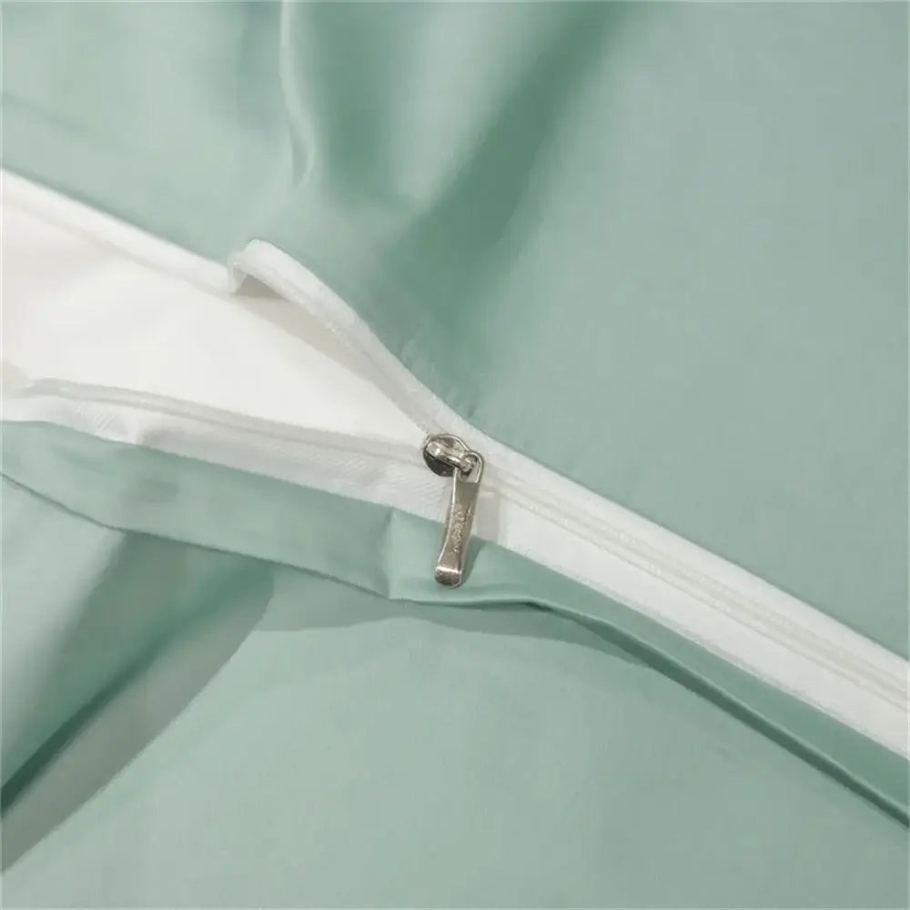 A sleek silver zipper on a mint-green duvet cover from the decorbites™ luxurious egyptian cotton bedding set