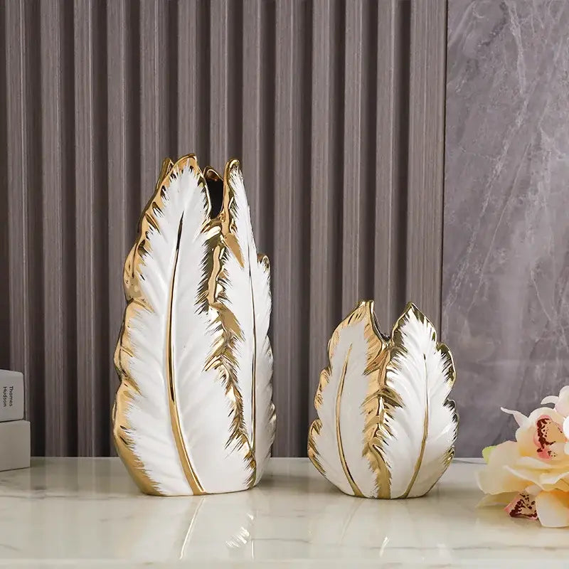 White ceramic gold ceramic vases by decorbites with gold leaf detailing shaped like stylized leaves for home decor