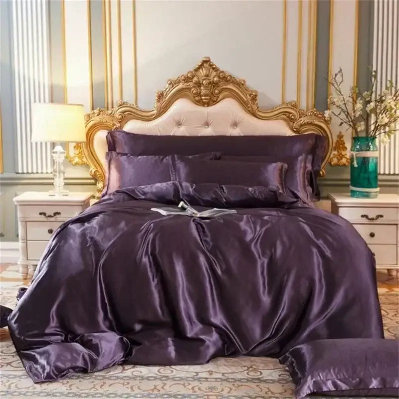 Purple satin mulberry silk bedding set with duvet cover and matching pillows on tufted cream headboard