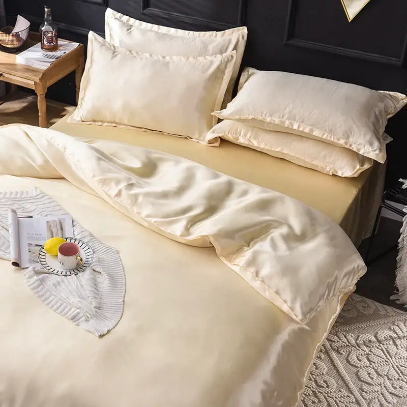 Cream-colored satin bedding set with smooth glossy finish and elegant stitched edges from DecorBites™ silk collection