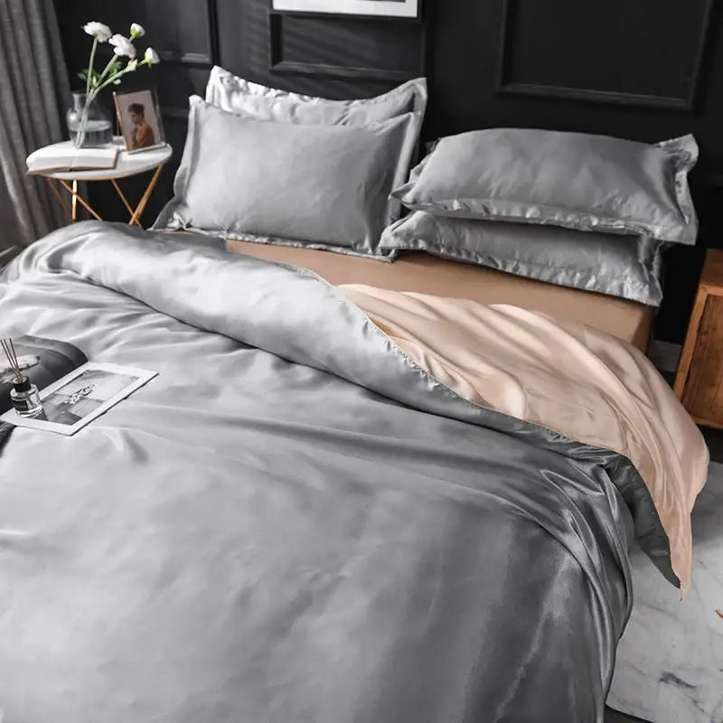 Decorbites™ luxurious silk bedding set featuring a sleek silver duvet cover with a soft beige satin finish interior