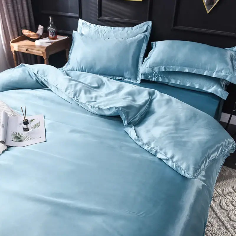 Light blue decorbites™ luxurious silk bedding set with smooth glossy satin finish and matching pillowcases in multiple sizes