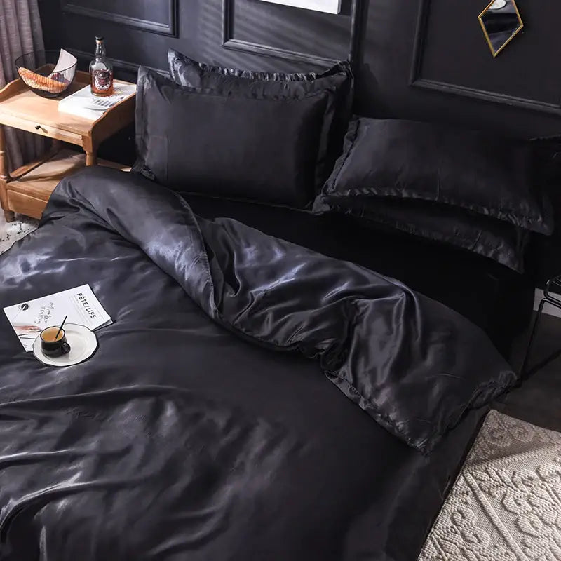 Black satin bedding set by DecorBites featuring a glossy duvet cover with smooth texture and elegant ruffled edges