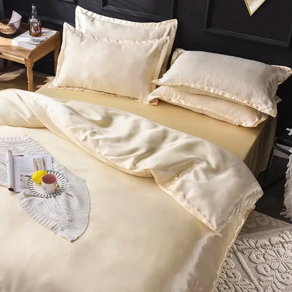 Cream-colored satin silk bedding set from decorbites with smooth glossy finish and elegant stitched edges