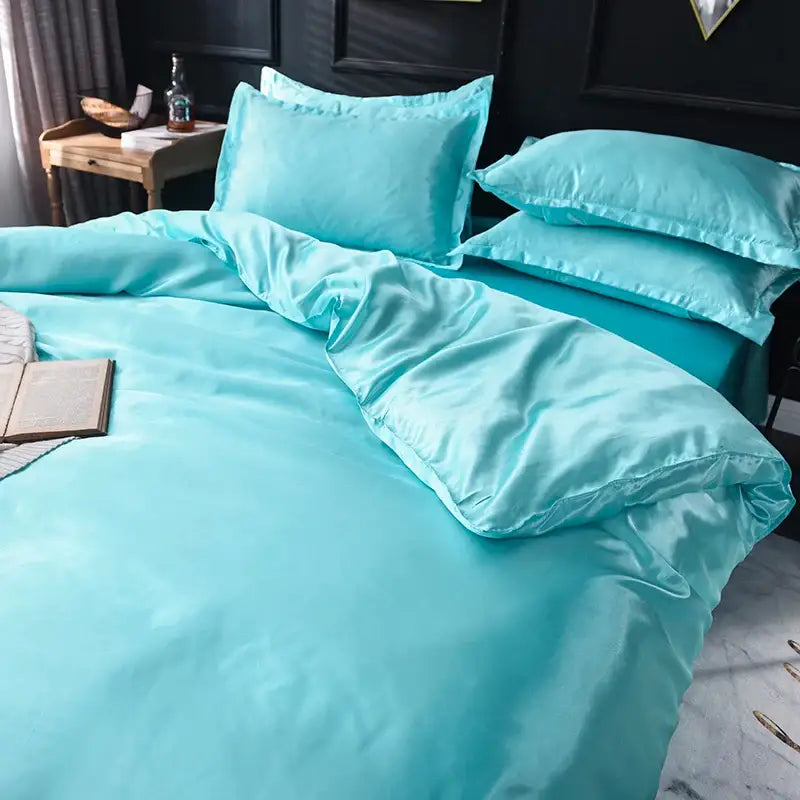 Turquoise satin duvet cover and bed sheet bedding set with a smooth glossy finish from decorbites™ luxurious silk collection