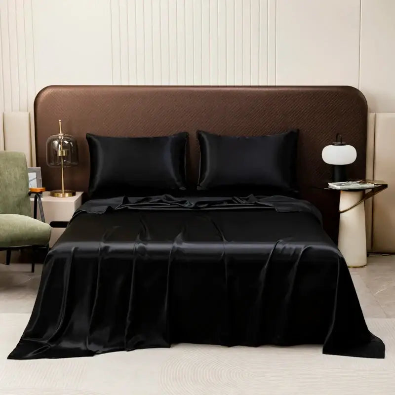 Black satin bedding set by decorbites with a solid color flat sheet and a smooth glossy finish