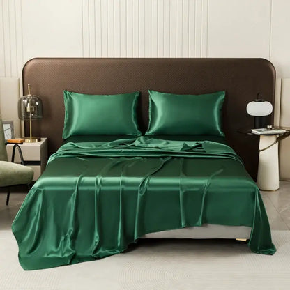 Decorbites™ luxurious solid color satin bedding set in emerald green featuring a smooth glossy flat sheet and pillowcases