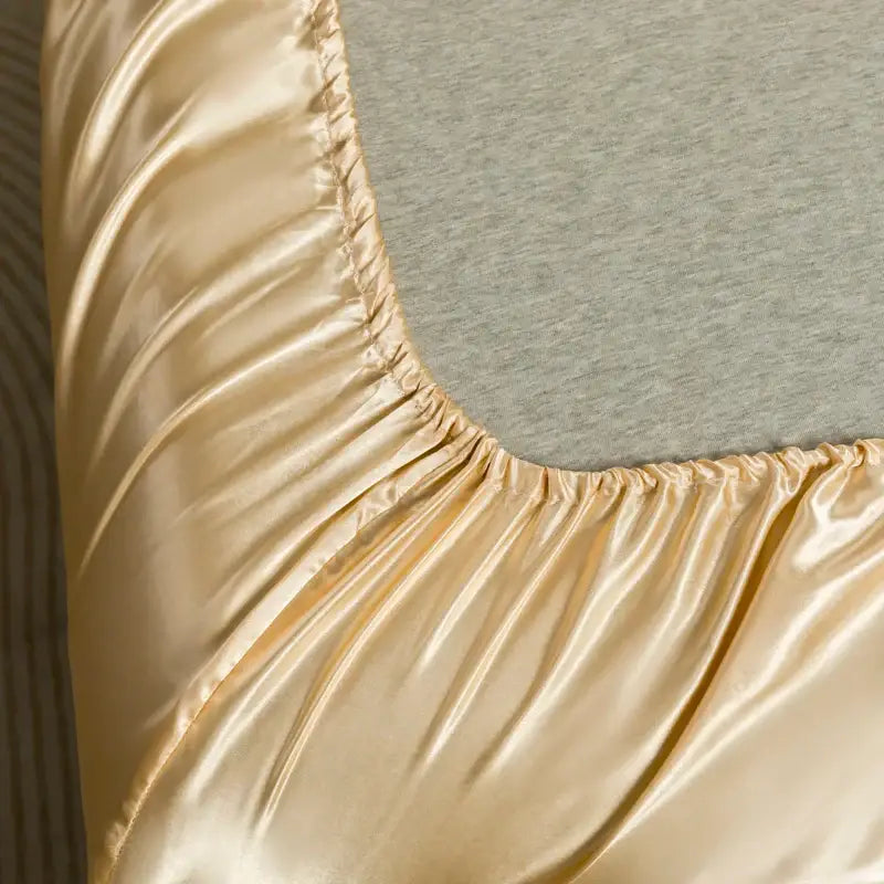 Decorbites™ luxurious solid color satin bedding set featuring a gold satin flat sheet with glossy finish and elasticized edge