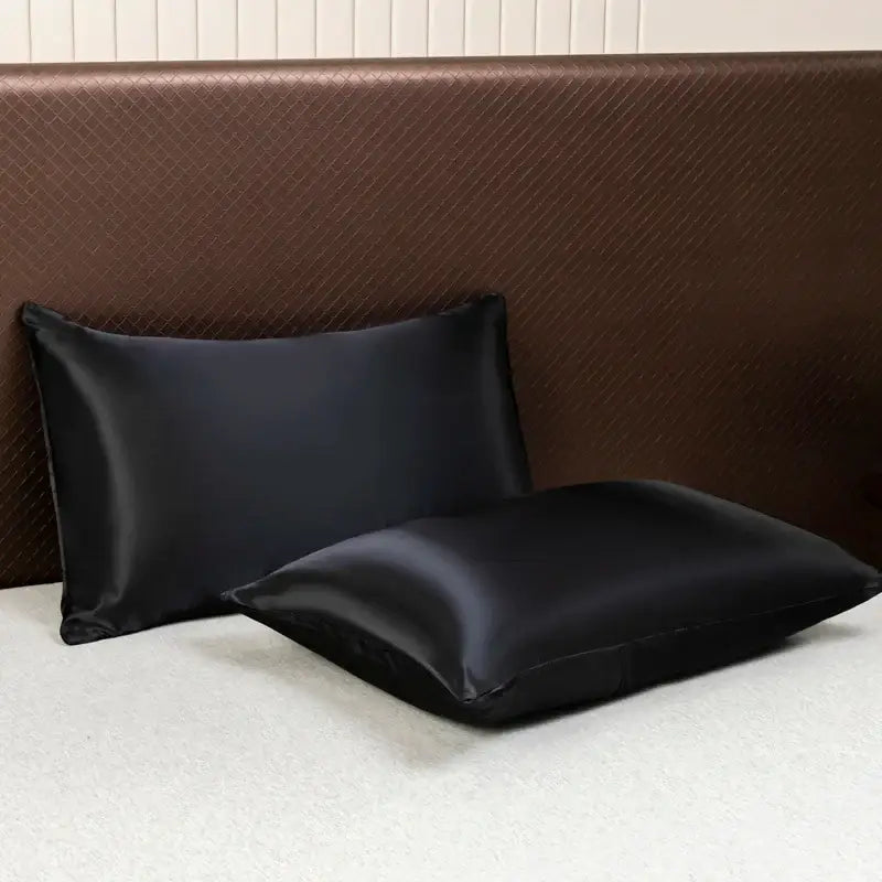 Two black satin pillowcases with a smooth glossy finish from the decorbites™ luxurious solid color bedding set