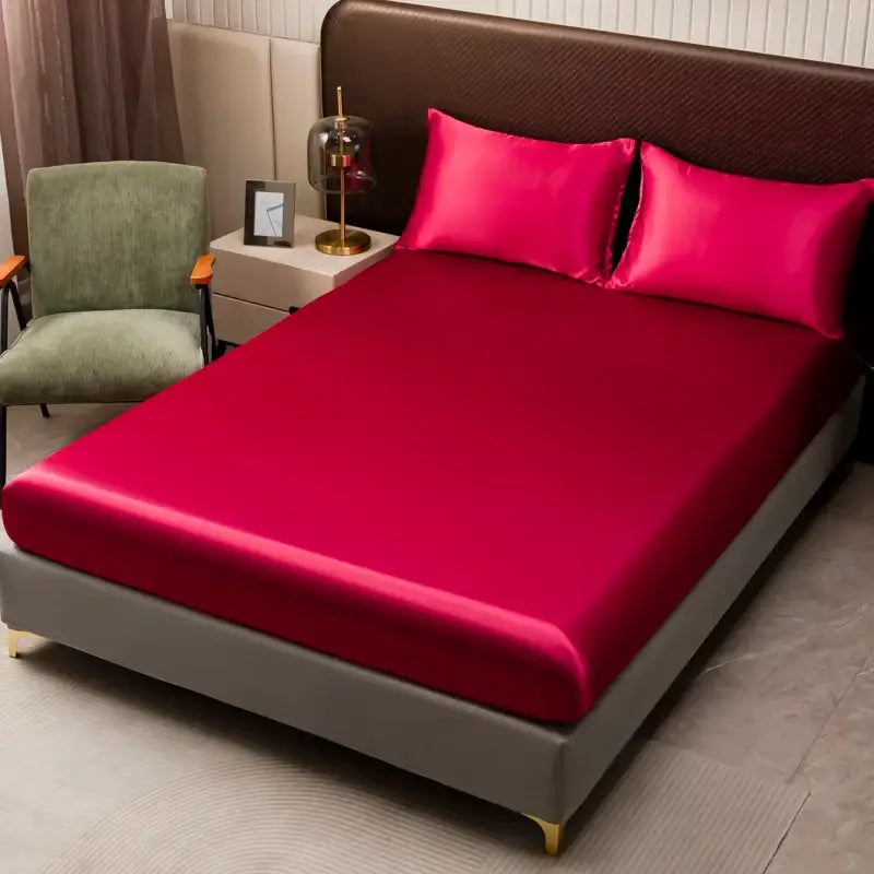 Vibrant fuchsia solid color satin bedding set with flat sheet and pillowcases on a modern gray bed frame