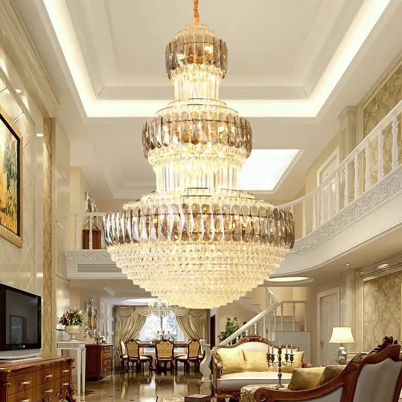 A decorbites luxury crystal multi-tiered chandelier with clear and amber crystals and a gold ceiling mount for dining rooms