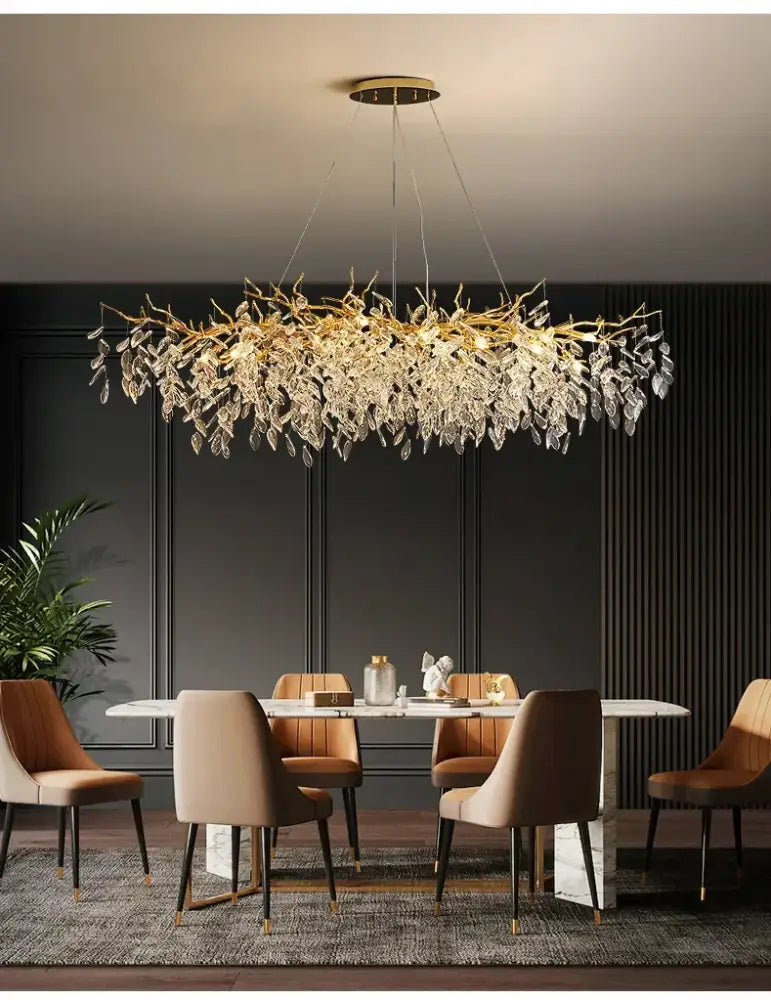 DecorBites™ luxury crystal chandelier with gold-tone branches and crystals hanging above a dining table